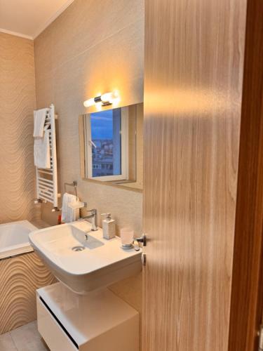 a bathroom with a sink and a mirror at Home Guest - Apartment 1 in Oradea