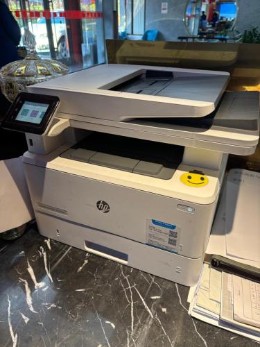 two printers sitting on top of each other at The Qomolangma Hotel Beijing China in Beijing