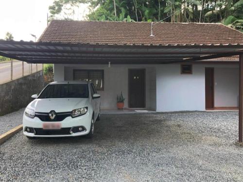 a white car parked in front of a house at Residência Vô José - Casa 01 in Pomerode