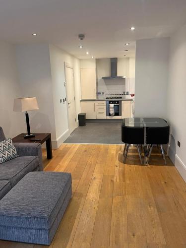 a living room with a couch and a table at Contemporary 1-Bed Apartment in The Bakery, Ormeau Road in Belfast