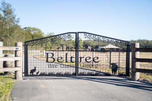 a gate with a sign that reads the beehive white company at The Beltree Wine Country Glamping in Belford