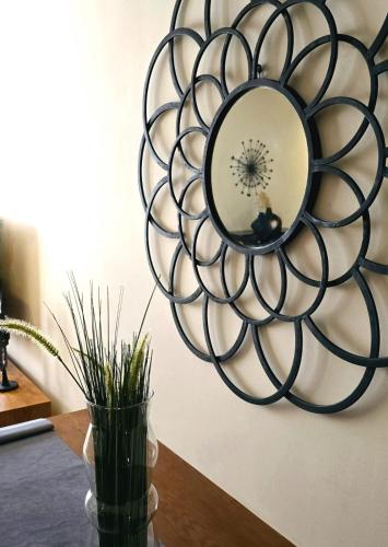 a circular mirror on a wall next to a vase at AS Premium By Soho Hotels Maarif in Casablanca