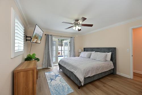 a bedroom with a bed and a ceiling fan at Bradenton Escape with Private Heated Pool in Bradenton