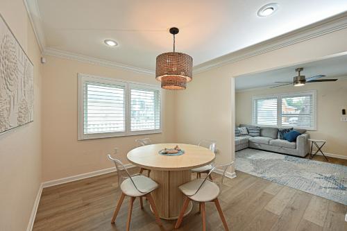 a dining room with a table and chairs and a couch at Bradenton Escape with Private Heated Pool in Bradenton