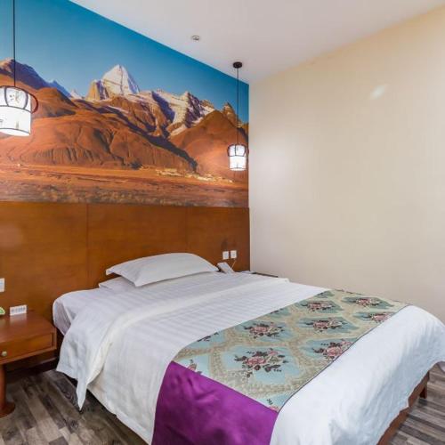 a bedroom with a large bed with a painting on the wall at The Qomolangma Hotel Beijing China in Beijing