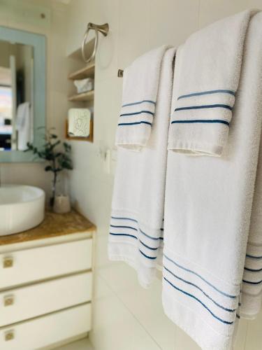 a bathroom with blue and white towels hanging on a wall at Casa Palencia Hotel and Breakfast in Mazatlán