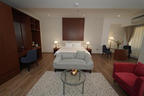 a hotel room with a bed and a couch at Villa Isabel Hotel in Sorsogon
