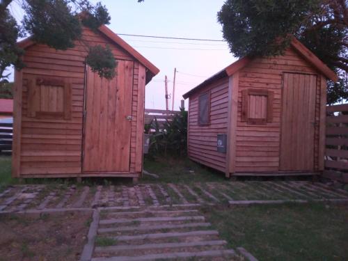 two wooden buildings sitting next to each other at Dormis LUYEMY in Mar del Plata