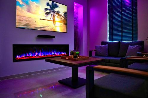 a living room with a couch and a fireplace at Wellness-Oase in Kerkrade