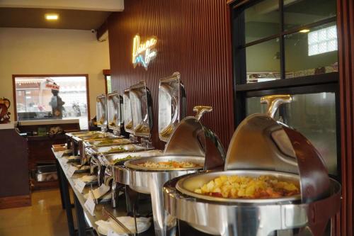 a row of food pans lined up in a row at Parama Bromo Hotel in Ngadisari