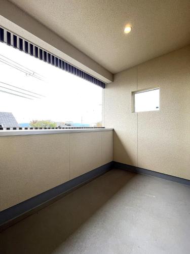 an empty room with a large window and a window sill at UMIIE-日置浜- Private STAY in Miyazu