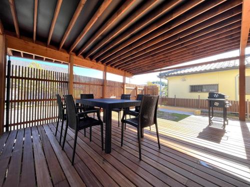 a patio with a table and chairs on a deck at UMIIE-日置浜- Private STAY in Miyazu