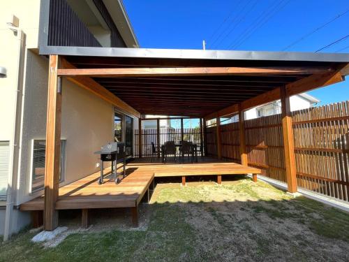 a wooden deck with a grill on a house at UMIIE-日置浜- Private STAY in Miyazu