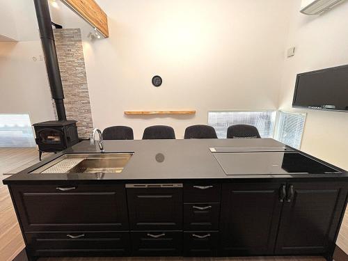 a large black desk with a sink in a room at UMIIE-日置浜- Private STAY in Miyazu