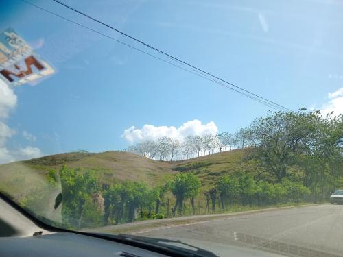 a view of a hill from a car windshield at Cabaña de Lucas in Loma Bonita
