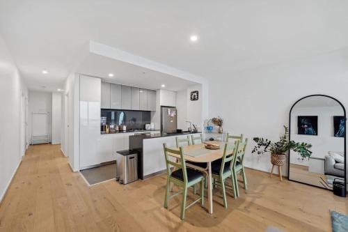 a kitchen and dining room with a table and chairs at Riverina - Ultimate Footscray Getaway with parking in Melbourne
