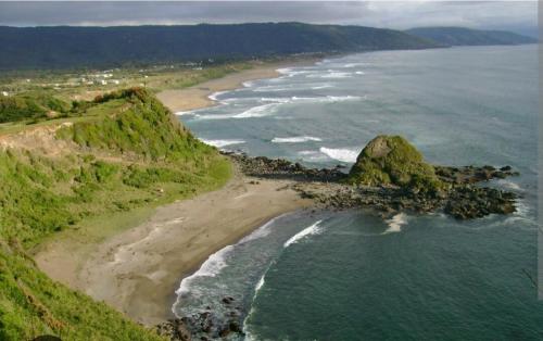 an aerial view of an island in the ocean at Cabañas del Escultor Cabaña Canelo in Valdivia