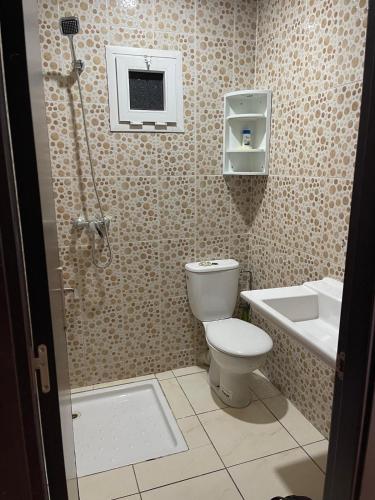 a bathroom with a toilet and a sink and a shower at luxury apartment in Agadir