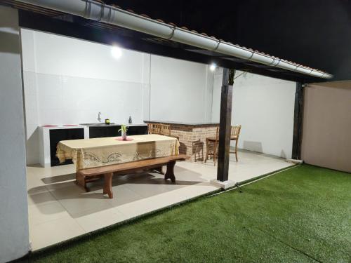 a kitchen with a table and a bench in a room at Casa Hospedagem Belém - COP 30 in Belém