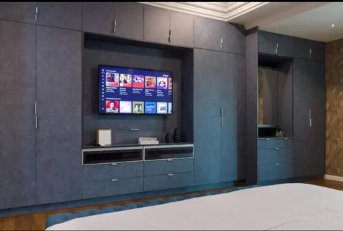 a room with a television on a wall at Luxury Villa in Ayer Keroh