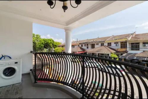 a balcony with a black railing and a washing machine at Luxury Villa in Ayer Keroh