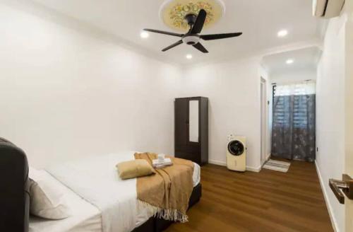 a bedroom with a bed and a ceiling fan at Luxury Villa in Ayer Keroh