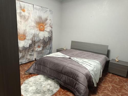 a bedroom with a bed with a flower mural on the wall at Villa Marie in Alpignano