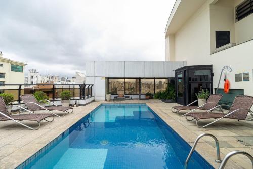 a swimming pool on the roof of a building at LFlats Hotel Alameda Lorena Jardins in Sao Paulo