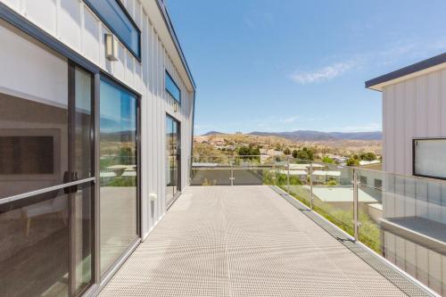 einen Balkon eines Gebäudes mit Straßenblick in der Unterkunft The Nix - 10 of 13 Reedys Cutting Road in Jindabyne