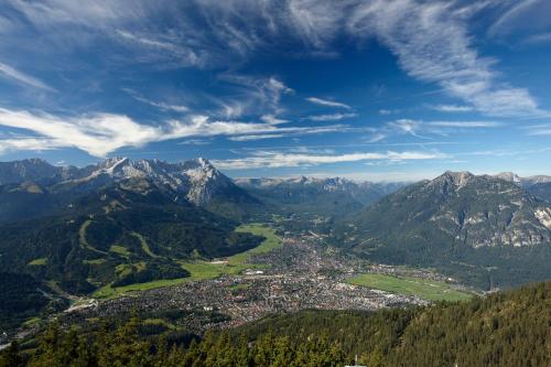 an aerial view of a town in the mountains at Hotel Zugspitze in Garmisch-Partenkirchen