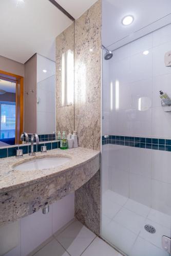 a bathroom with a sink and a shower at LFlats no Hotel Stella Vega (EX-Mercury Ibirapuera) in Sao Paulo
