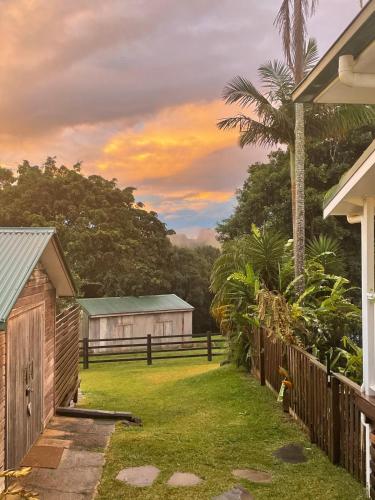 a house with a yard with a fence at Black Cockatoo Bangalow in Binna Burra