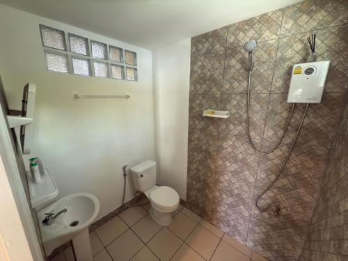 a bathroom with a shower and a toilet and a sink at Mem Homestay in Ban Khlong Wang Chang