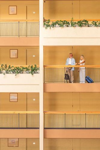 a couple standing on a balcony of a building at Sydney Harbour Hotel in Sydney