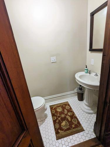 a bathroom with a toilet and a sink at The John Sydney House in Hannibal