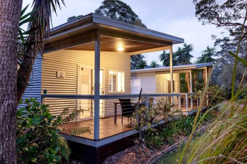 a house with a wrap around porch with a deck at BIG4 South Durras Holiday Park in Durras