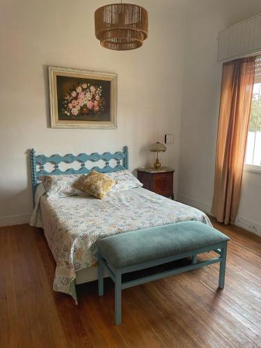a bedroom with a bed with a blue head board at Casa de campo en Torres in Luján