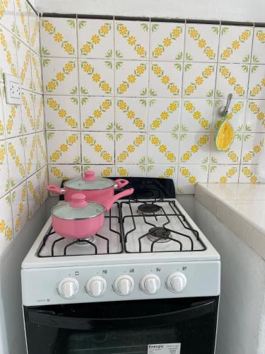 a kitchen stove with two pots and pans on it at Casa de campo en Torres in Luján