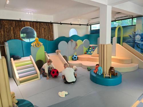 a group of children playing in a play room at Koh Mak White Sand Beach in Ko Mak