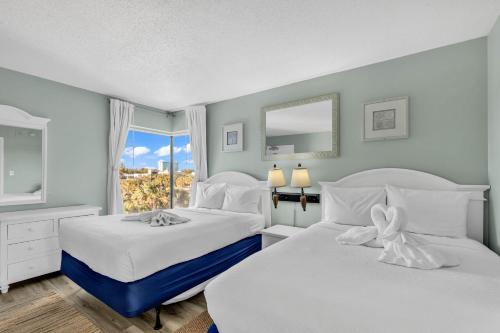 a bedroom with two beds and a window at Hosteeva 1BR Oceanfront Condo in Atlantica Resort near Boardwalk in Myrtle Beach