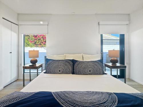 a bedroom with a large bed with two night stands at Villa Caliente in Palm Springs