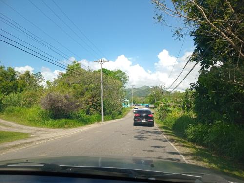 a car is driving down a road at Cabaña de Lucas in Loma Bonita