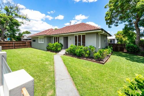 a house with a green yard at Boutique Living East Toowoomba in Toowoomba