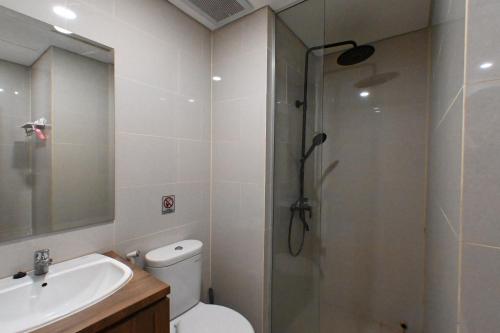 a bathroom with a shower and a toilet and a sink at Apartment Medan Podomoro City Deli by OLS Studio in Medan