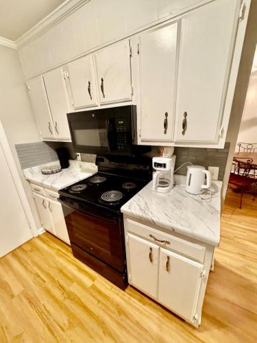 a kitchen with white cabinets and a stove top oven at Apartment in Lexington, SC in Lexington