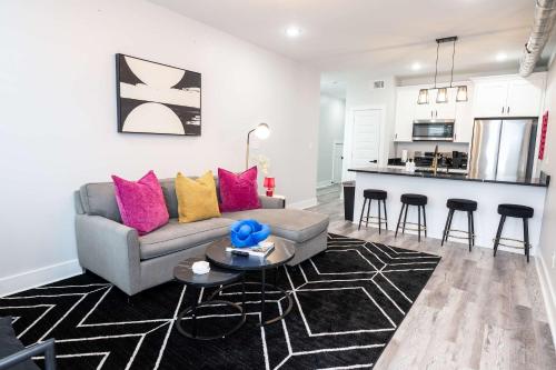 a living room with a couch and a kitchen at Mid City Magic 5 in New Orleans