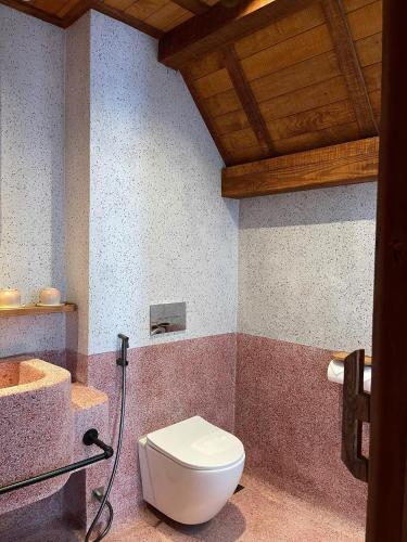 a bathroom with a toilet and a sink at The Pink Boutique Hotel in Da Lat