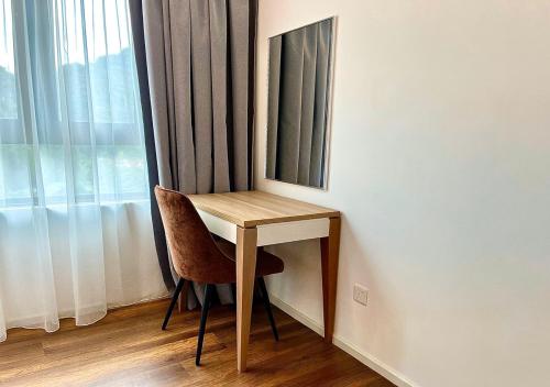 a desk with a chair and a mirror in a room at Hotspring 1203 Two Bedroom at Sunway Onsen 4pax in Tambun