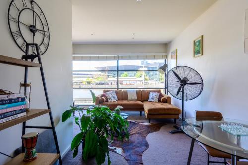 a living room with a couch and a glass table at Luxurious Apartment in the heart of Docklands in Melbourne