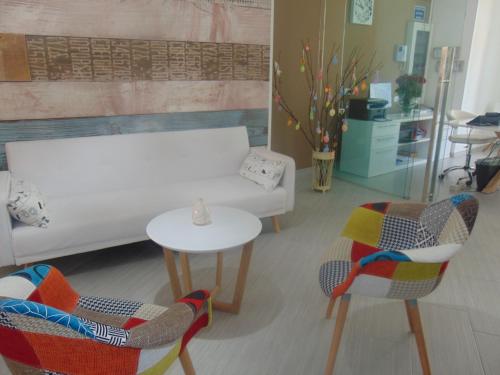 a living room with a couch and chairs and a table at Residence Le Isole in Marsala
